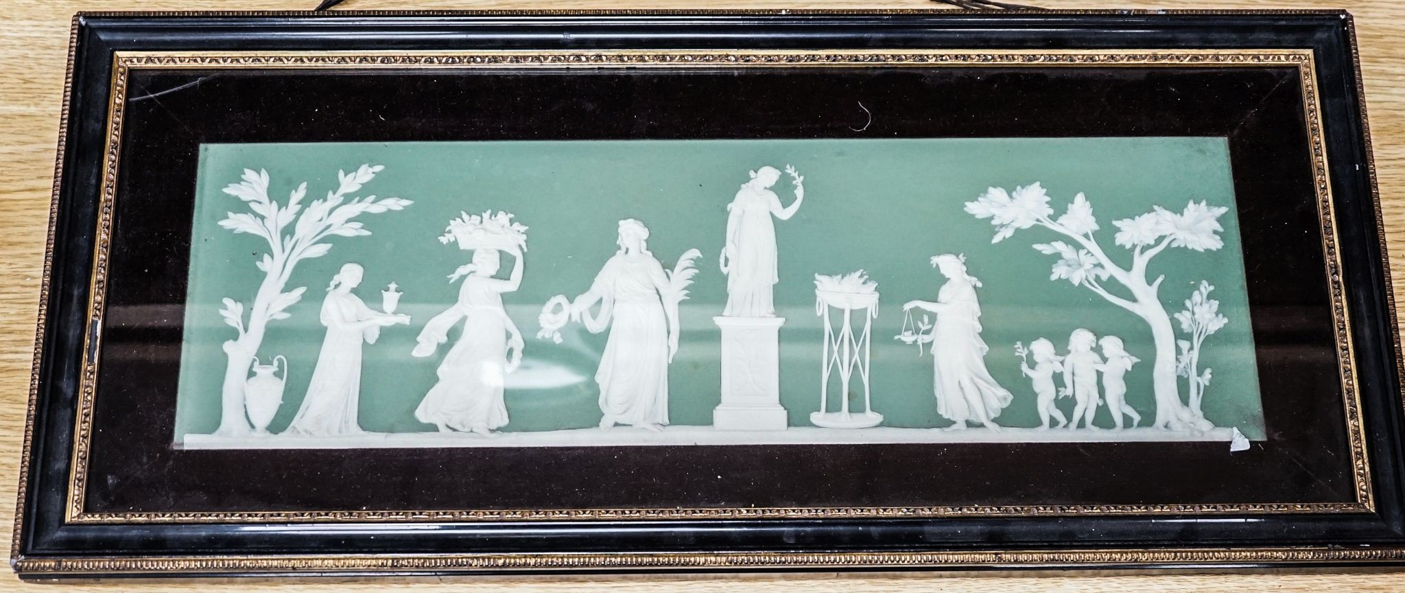 A Wedgwood jasperware plaque, framed. 15x48cm excl. frame